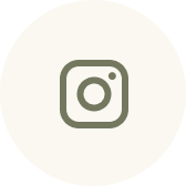 Instagram logo in green on a light beige circular background.