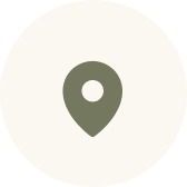 Map location pin icon in muted green on a light circular background.